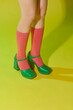 © Marc Tran/Stocksy - Woman wearing bright socks with sandals and space for design