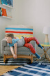 © Jenna Elliott/Stocksy - Boy Slumped on Chair Looking Bored