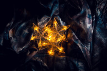 Bright Five-pointed Stars, On A Textured Surface. Shining Plastic Stars On The Substrate At Night.