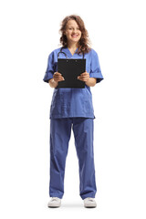 Poster - Female nurse in a blue uniform holding a clipboard and smiling