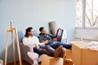 © ALTO IMAGES/Stocksy - Positive multiracial male friends in casual clothes sitting on sofa