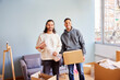 © ALTO IMAGES/Stocksy - Smiling multiracial male friends standing in living room near window