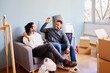 © ALTO IMAGES/Stocksy - Happy male friends in new apartment