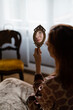 © Mauro Grigollo/Stocksy - A woman looks at herself in the mirror