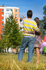 Poster - happy young couple near their new home