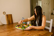 © ByLorena/Stocksy - Woman Preparing fruit and veggie charcuterie board