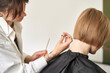 © Ivan Ozerov/Stocksy - Crop hairdresser cutting hair of client