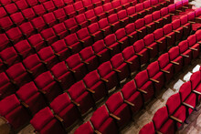 Red Rows Of Bright Empty Seats In Theater