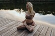 © Anastasia Mihaylova (Shpara)/Stocksy - Woman doing yoga outside in the summer on pier