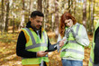 © Oleksii Syrotkin/Stocksy - Ecology activist forest team gadget smartphone organiser
