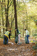 © Oleksii Syrotkin/Stocksy - Environmental volunteering trash human impact teamwork woodland