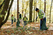 © Oleksii Syrotkin/Stocksy - volunteers team partnership together assist eco friendly