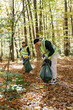 © Oleksii Syrotkin/Stocksy - volunteering service group environment  rubbish co operation