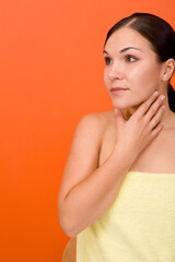 Poster - attractive and fresh brunette woman on orange background