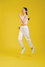 Young Pretty Girl Jumping Isolated On Yellow Background
