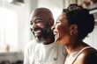 © TRINETTE + CHRIS - Black couple laughing while cooking together in kitchen at home.