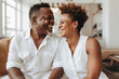 © Trinette Reed - Portrait of happy mature successful Black couple laughing at home. Generative AI.
