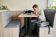 © J Esteban Berrío/Stocksy - University student enjoying a snack in a cafeteria