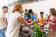 © Luis Velasco/Stocksy - Multiracial Group Of Friends Cooking A Meal Together.