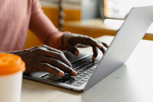 Male Hands Typing On A Laptop Keyboard