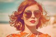 © Dejan - A stunning woman showcases her impeccable style with retro sunglasses, making a statement against the beach backdrop