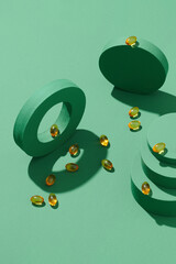Yellow gelatin capsules on a green background