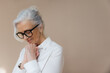 © Rob and Julia Campbell/Stocksy - Woman in simple studio with serious expression.