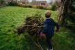 © Vradiy Art/Stocksy - Boy with cart helping with gardening