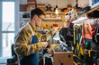 © Daniel Gonzalez/Stocksy - Focused man standing and working in repair shop