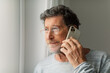 © Studio Firma/Stocksy - Senior Man on Phone Call