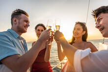 Group Of Diverse Friends Drink Champagne While Having A Party In Yacht. 