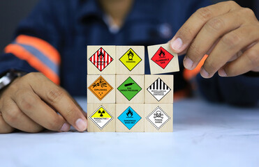 security officers arrange dangerous warning sign icon on wooden cube for operator safety such as exp