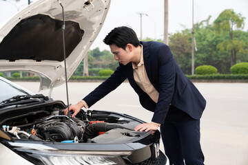 Young Asian business man with car