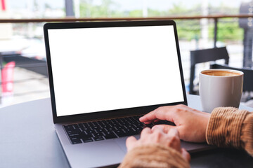 Wall Mural - mockup image of a woman using and working on laptop computer with blank white desktop screen