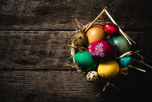 Easter Eggs In Nest On Rustic Wooden Planks