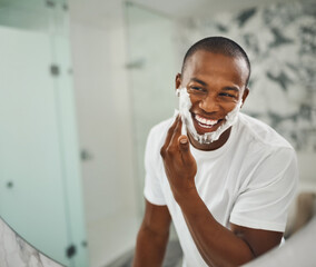 Fototapete - Black man, foam and happy for shaving, grooming and cosmetics in mirror for self care in home. Young african guy, soap or cream for facial hair, beard and cleaning for hygiene with smile in morning
