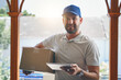 © Nikish H/peopleimages.com - Happy delivery man, box and tablet in logistics, ecommerce or courier service at front door. Portrait of male person smiling with package, carrier or cargo for online purchase, order or transport