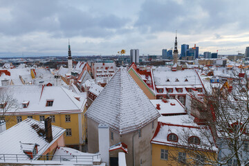 Wall Mural - TALLINN, ESTONIA - JAN 15, 2023: Snow-covered roofs of houses in old town of Tallinn after snowfall