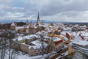 Wall Mural - TALLINN, ESTONIA - JAN 15, 2023: Snow-covered roofs of houses in old town of Tallinn after snowfall