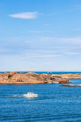 Poster - Boat on a rocky archipelago at summer