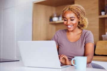 Woman using laptop computer while working from home