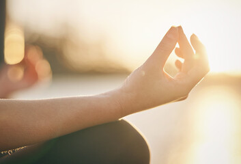 Hand, yoga and lotus pose with woman at sunrise, fitness outdoor with meditation and wellness for mental health. Sunshine, female person meditate and zen with exercise, healing and mindfulness