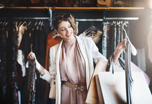 Stylist, Rich Or Happy Woman Shopping In Boutique Store Looking At Clothes Or Choosing Her Favorite Style. Choice, Decision Or Female Designer With Trendy Apparel Picking An Outfit Or Classy Fashion