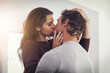 © AS/peopleimages.com - Couple, love and kissing in home for romantic bond, quality time and care together. Young man, woman and kiss for romance of lovers in happy relationship, intimate moment and passionate affection