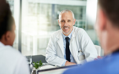 Canvas Print - Portrait, man and doctor with team in office for meeting, clinic collaboration and leadership of medical partnership. Happy healthcare worker, manager and expert consulting with employees in hospital