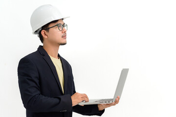 Asian male architect or engineer wearing white hard hat holding laptop isolated on white background Copy space over a white studio background.