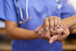 © N Hiraman/peopleimages.com - Nurse, patient and holding hands for support, healthcare service and helping, muscle exam or arthritis. Professional doctor, medical or homecare woman, hand together sign and health check or nursing