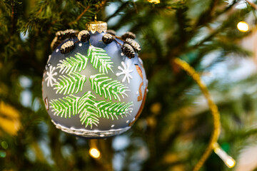 Canvas Print - glass ball decorated of fir tree needles on natural christmas tree indoor close up