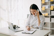 © Nuttapong punna - Happy asian business woman have the joy of talking on the smartphone, tablet and laptopon the  office .