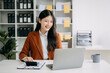 © Nuttapong punna - Asian businesswoman working in the office with working notepad, tablet and laptop documents in office